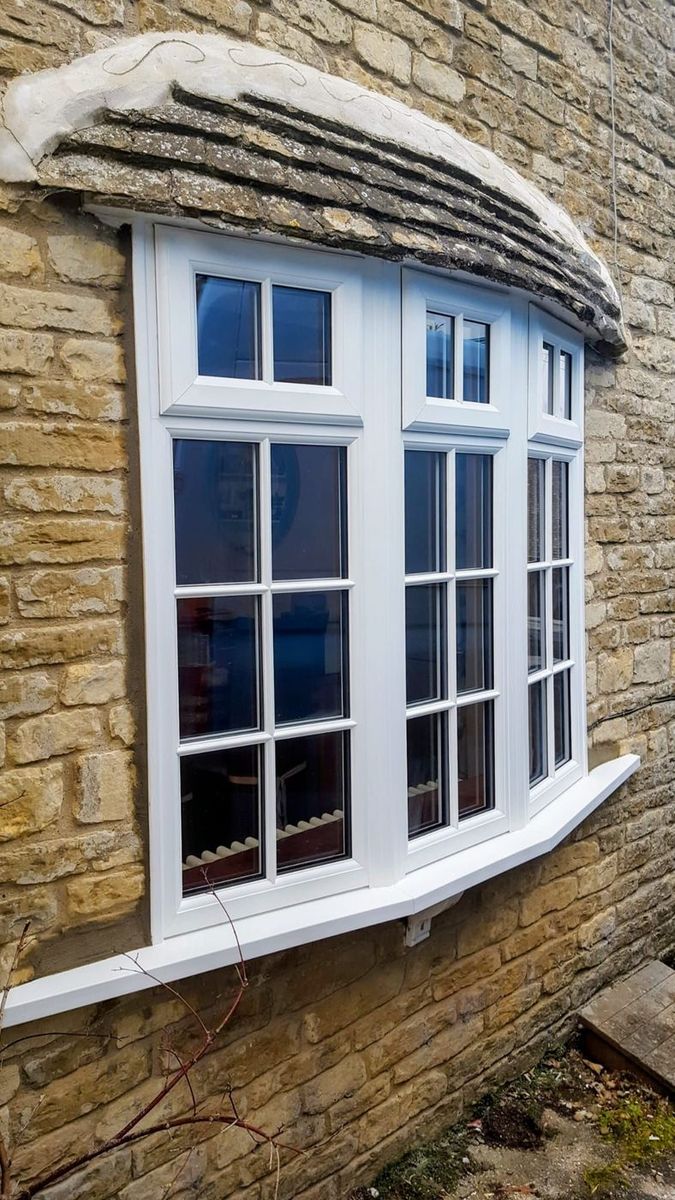 Georgian-bar windows on stone cottage